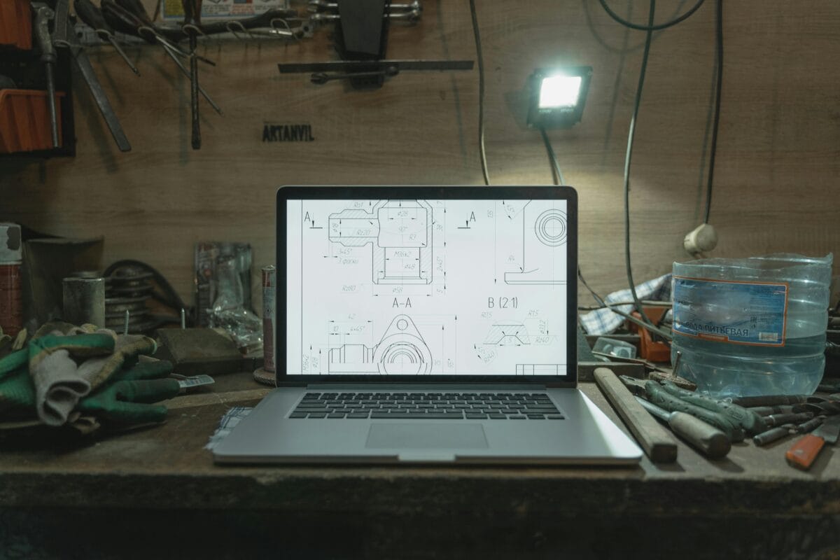laptop in a room with bulb light and tools