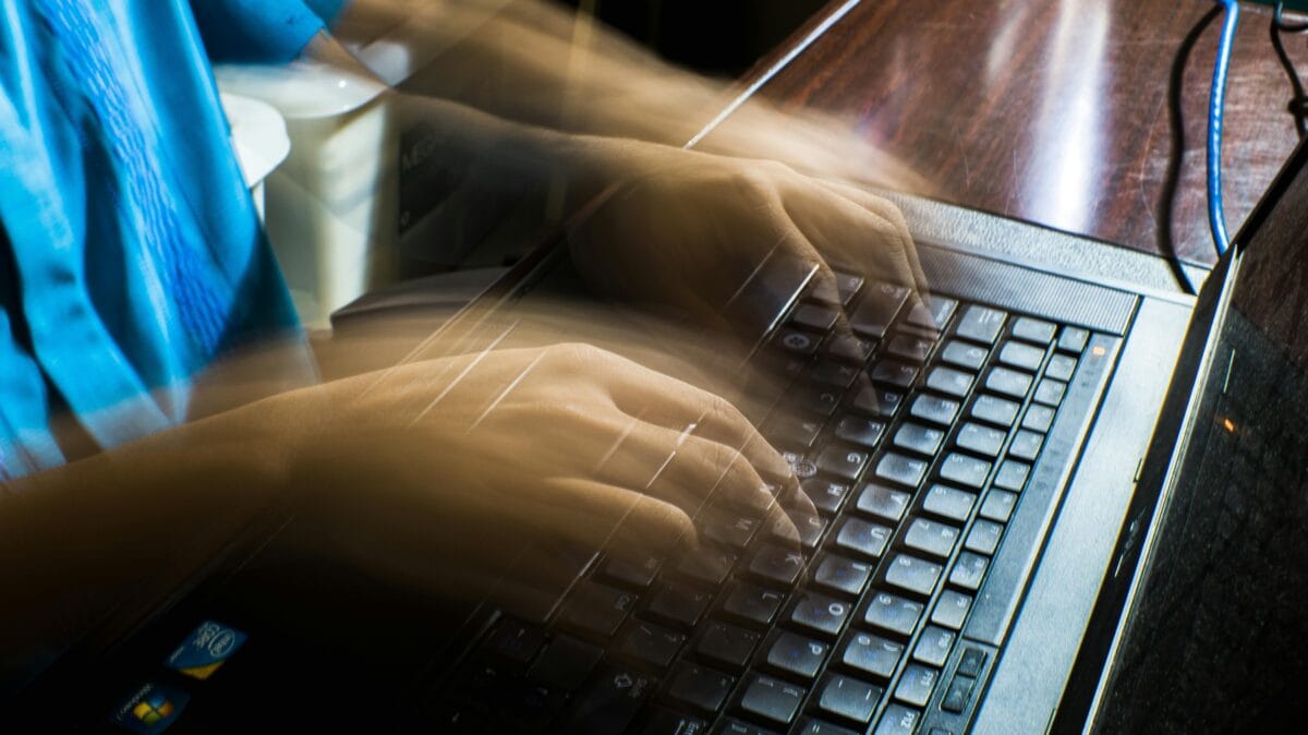 someone typing in a laptop